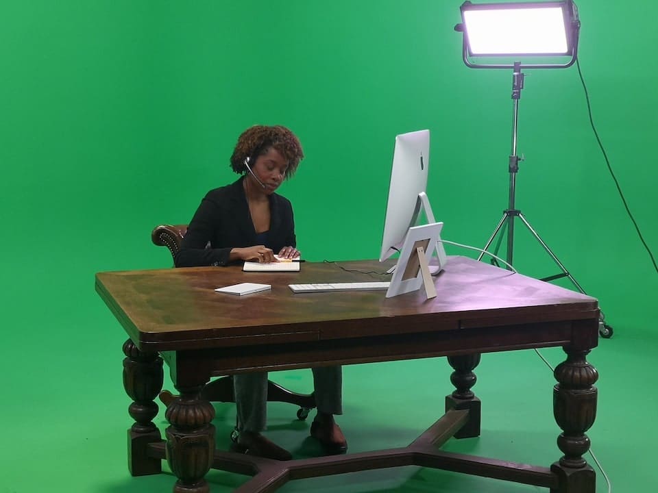 Person working at computer in green studio
