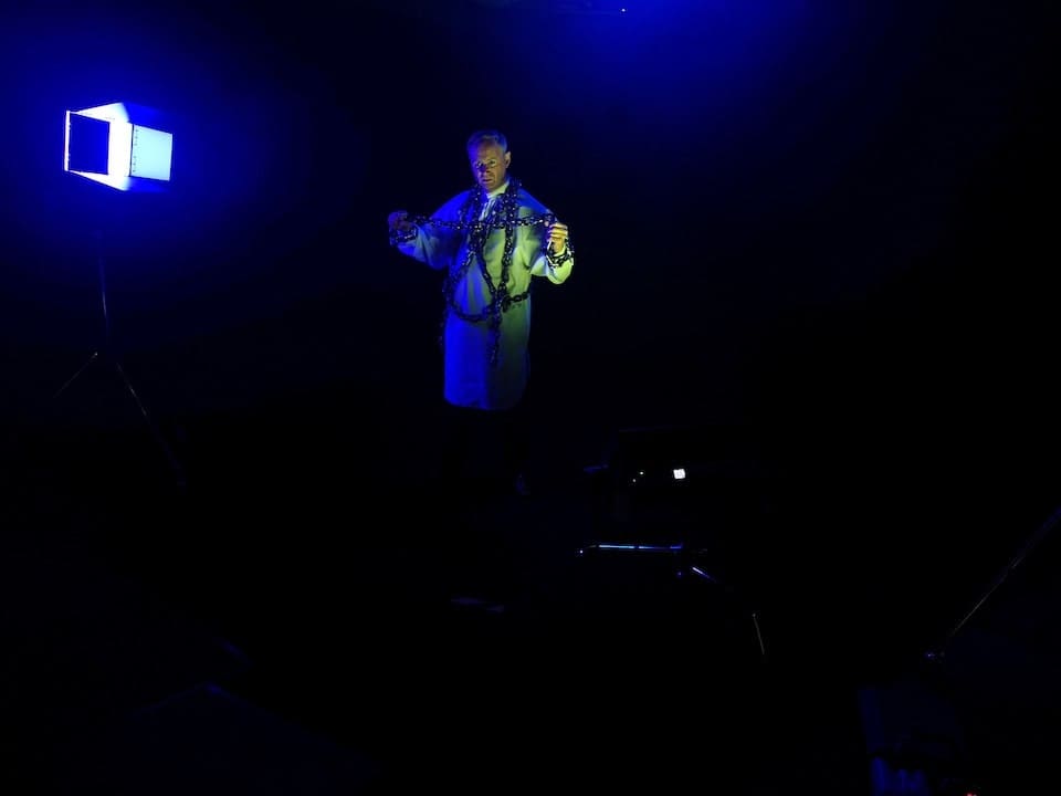 Man performing in blackout studio Manchester with film lighting