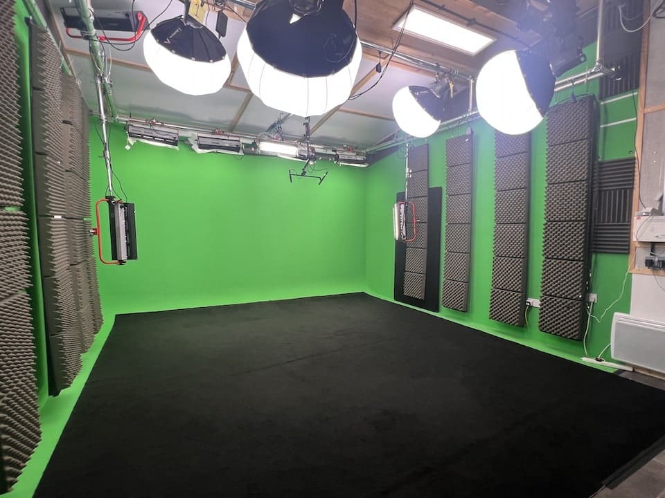 Professional green screen studio with lighting equipment