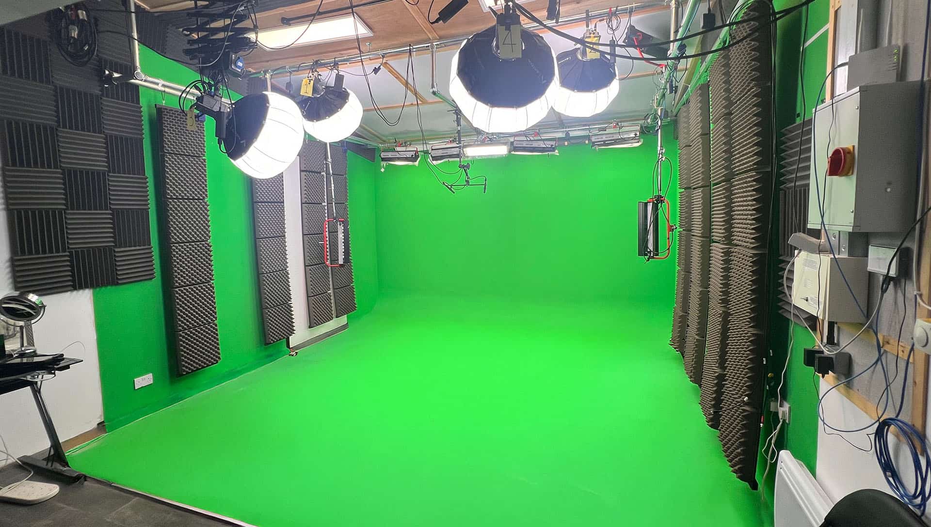 Green screen studio with professional lighting setup Green screen studio with professional lighting setup