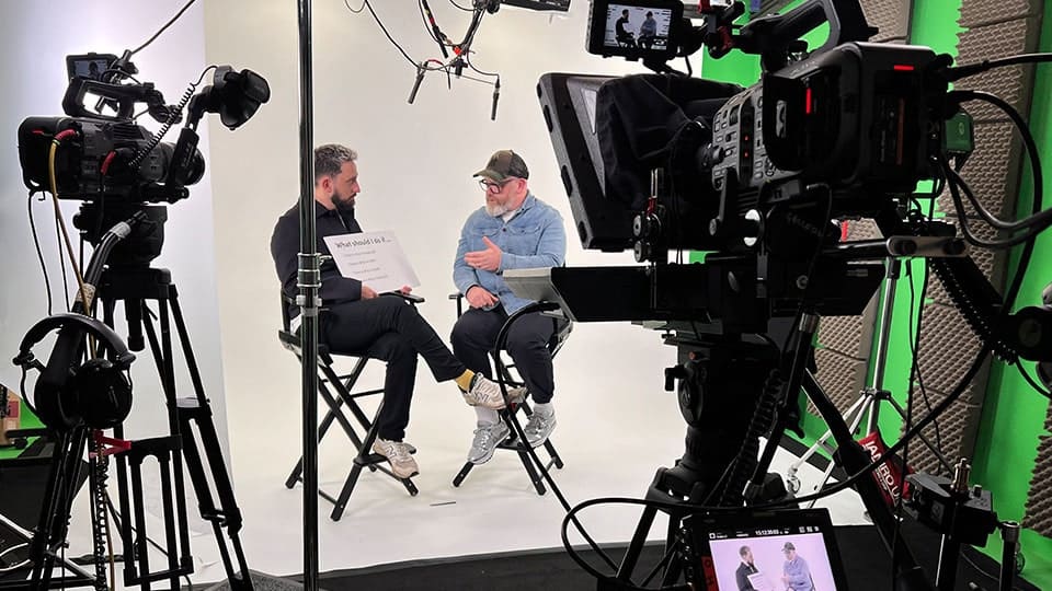 Video production studio setup with two people talking.