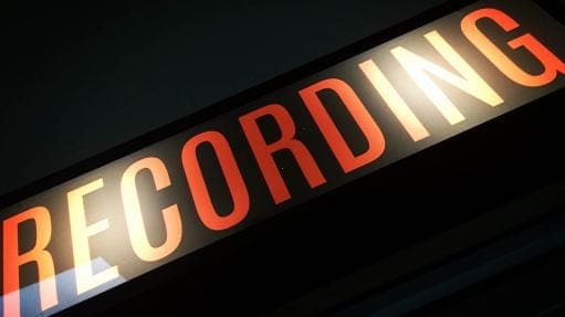Recording studio sign glowing in dim light